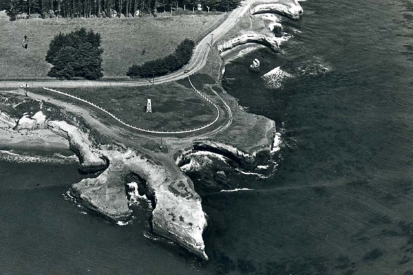 Aerial view of Lighthouse Point in 1957. The beacon stands alone. The only traces of the lighthouse are the cypress trees that outline where it stood from 1878 to 1948. Image is used courtesy of Frank Perry.