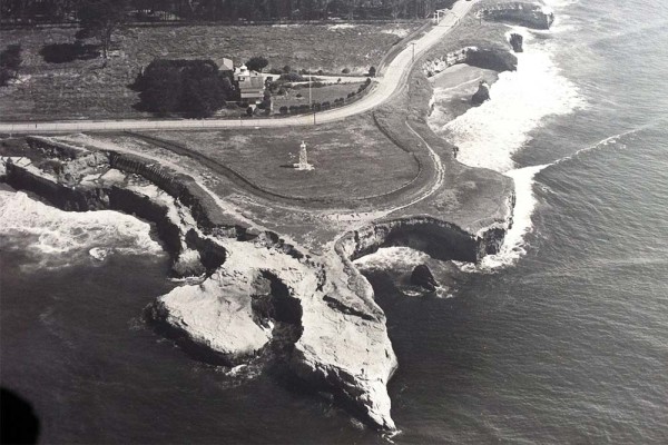 Aerial view of Lighthouse point circa 1941. You can see the beacon and the old lighthouse on the north side of West Cliff Drive. Image is used courtesy of Frank Perry. Ed Webber was the photographer.