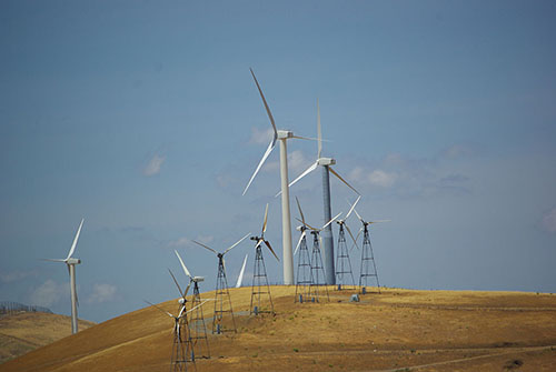 Newer monopole turbines tower above the old lattice base turbines from the 1980s, 2008. Photo by David J Laporte.