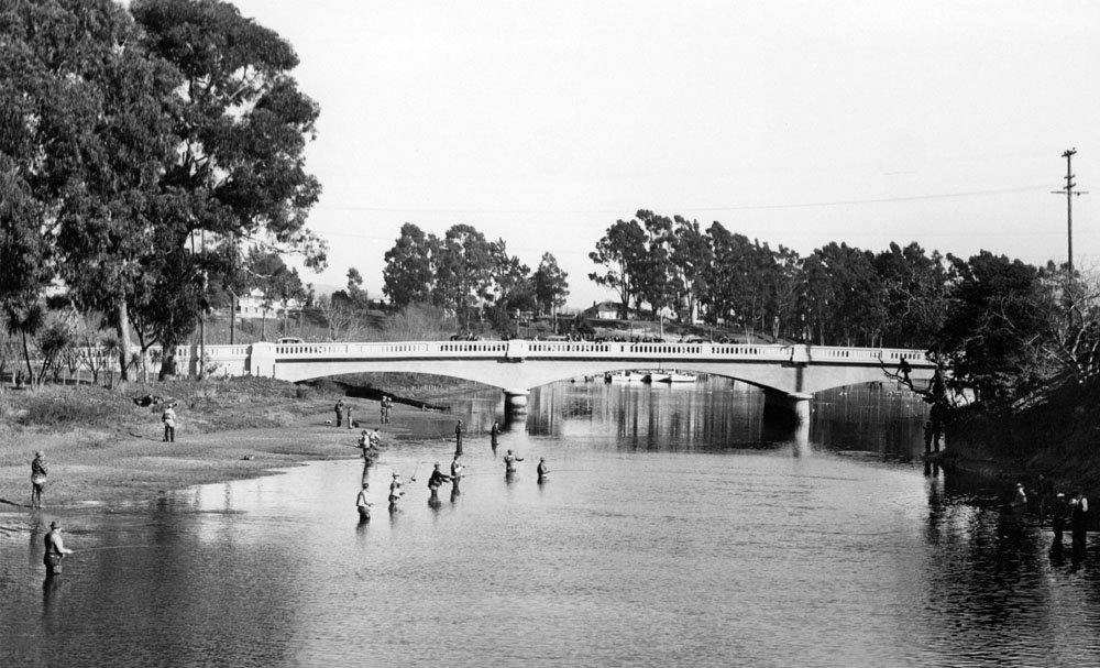 Fisherman try their luck for coho salmon and steelhead trout in the San Lorenzo River near the Riverside Avenue bridge. Picture courtesy of and © Santa Cruz Public Library.