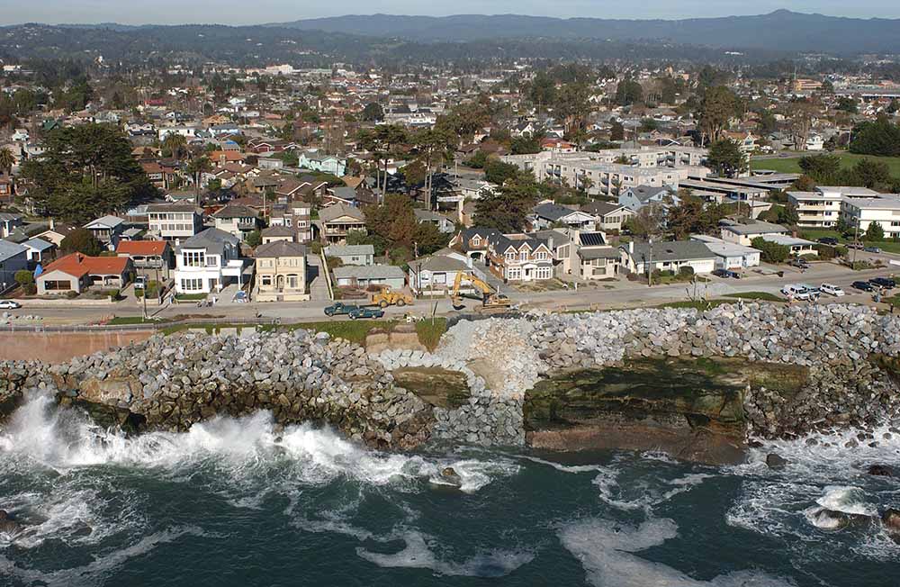 A view from the mountains to the eroding coast along West Cliff Drive in 2010. Picture © Kenneth and Gabrielle Adelman, California Coastal Records Project www.Californiacoastline.org.