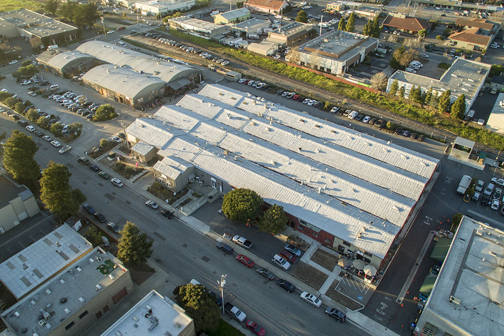 An aerial view of Swift Street Courtyard (upper left) and adjacent 334 Ingalls Street Building (lower right) in February 2015. Photo © 2014 www.MultiRotorCam.com.